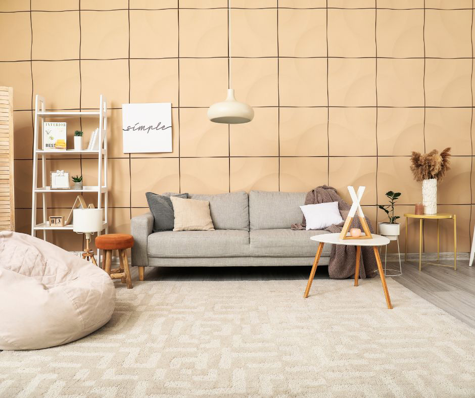 A living room with carpet, bright light, wall coverings, and soft furnishings.