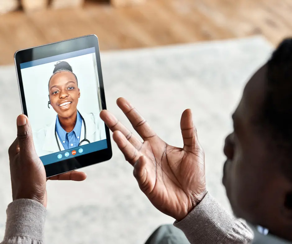 A man has a telehearing appointment on a tablet. 