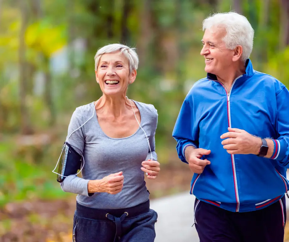 An older couple jogs outside.