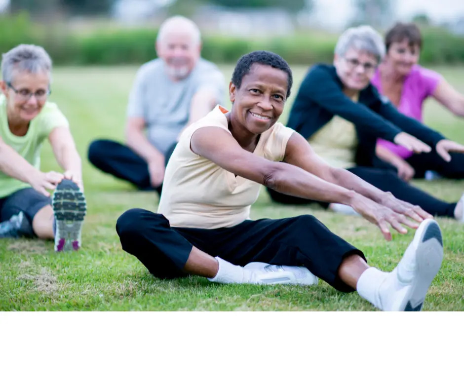 A group of seniors does yoga outside. 