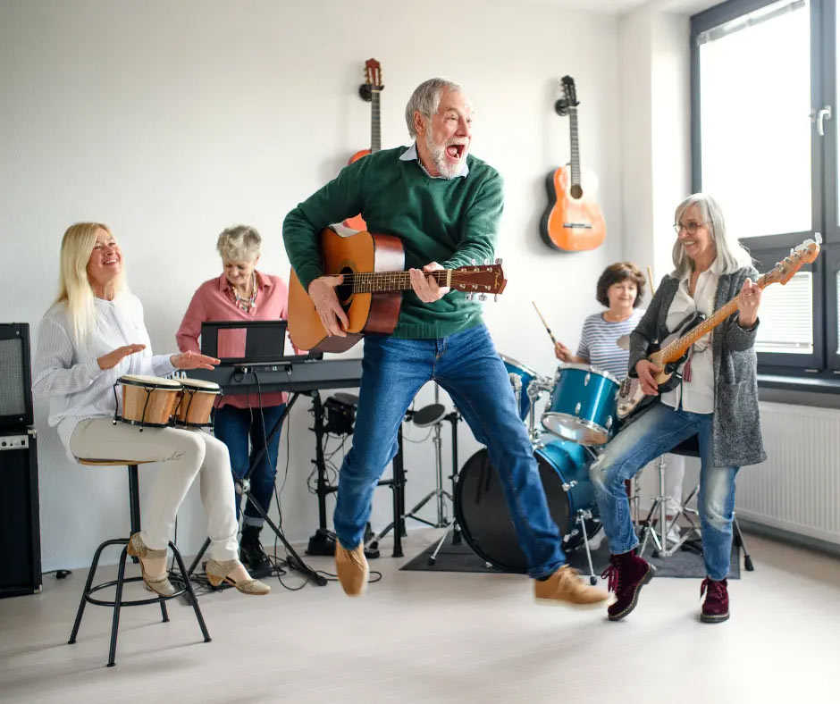 Five older people play instruments together happily.