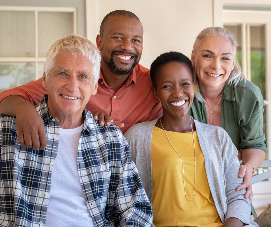 Happy older couples smile at the camera. 