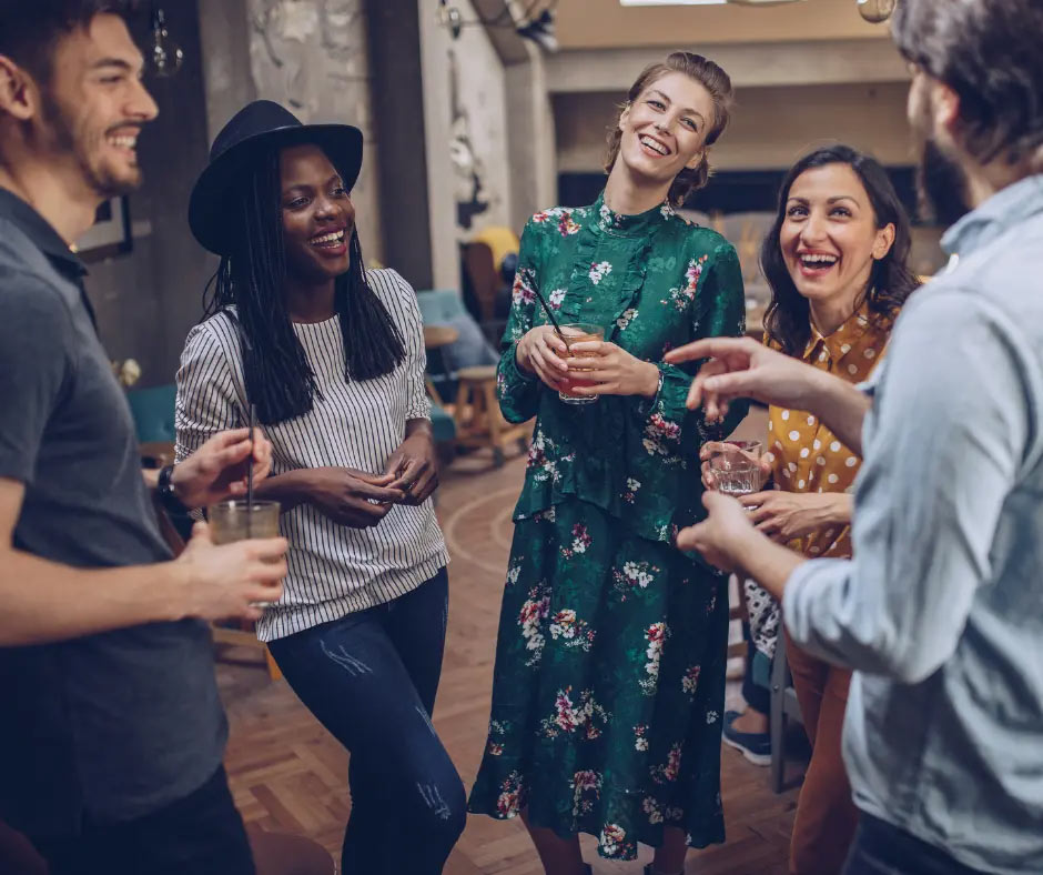 People of varying ages laugh together at a party.